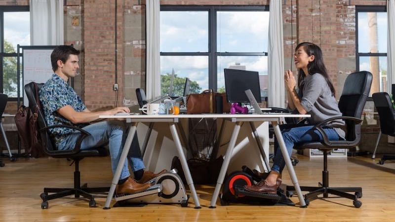 office workers using cubii pro at desk
